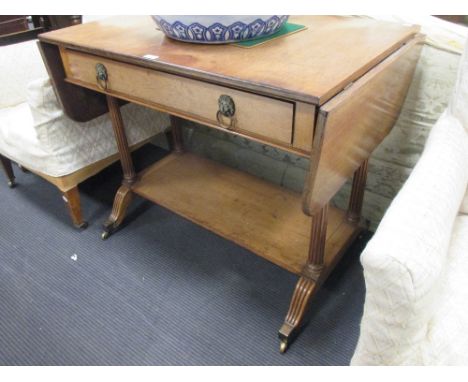 A mahogany sofa table with Howard label, fitted with a rosewood lined drawer on reeded legs  