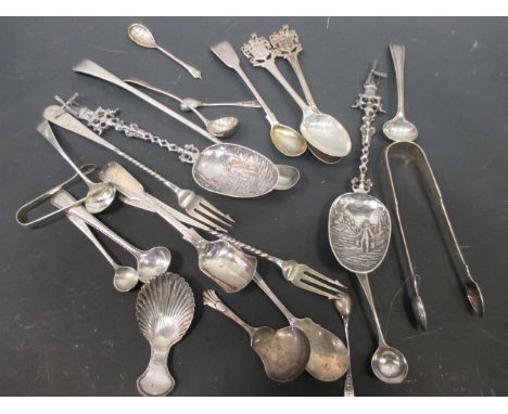 A collection of small silver flatware to include salt/mustard spoons, caddy spoons and sugar tongs  