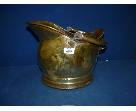 A Brass helmet shaped coal bucket.