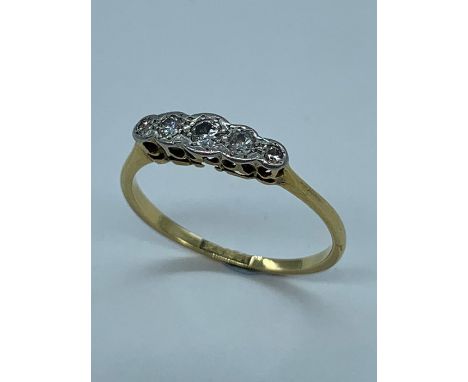 A five stone diamond ring on 18ct gold and platinum.