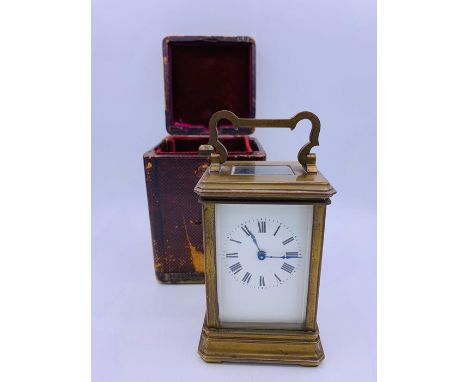 A brass carriage clock made in France with leather travelling box and key 