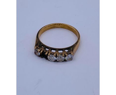 An 18 ct gold five stone ring with a stone missing (2.8g)