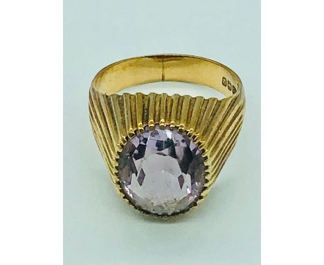 A 9ct gold cocktail ring with amethyst style stone.