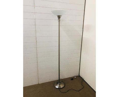 A contemporary brushed chrome floor standing lamp with glass shade 