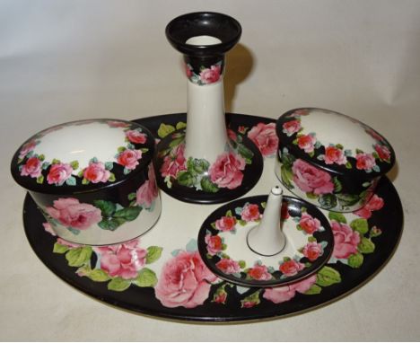 A George Jones Crescent China Dressing Table Set decorated with roses comprising; oval tray, two covered boxes, candlestick a