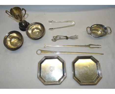 A pair of octagonal shallow Dishes, raised on bun feet and engraved with a crest, London, 1933, maker William Comyns & Sons, 