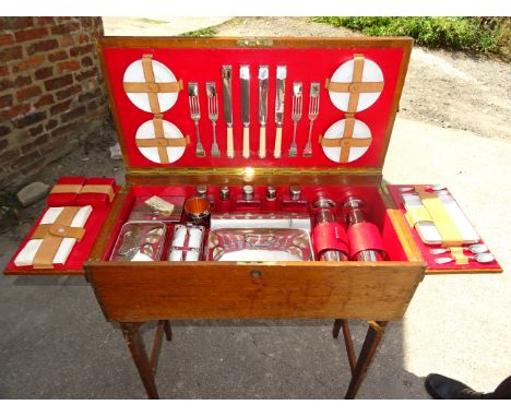 An early 20th Century oak Picnic/Card Table with fold over baize lined top, the interior comprehensively fitted with chromium