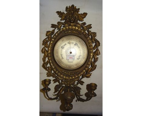 An aneroid Barometer inscribed Wilson & Sharp, Princes Street, Edinburgh in a classical brass case with three candle sconces,