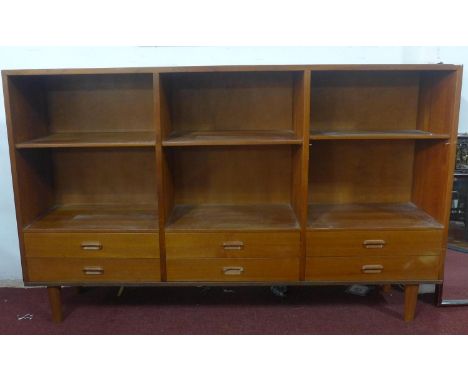 A 20th century teak unit with adjustable shelf space, above 6 drawers, raised on tapered legs, H.99 W.160 D.34cm 