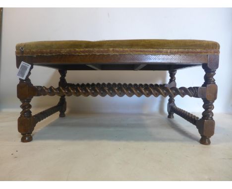 A large 19th century oak stool, with tapestry upholstery, raised on barley twist supports and stretchers, H.42 W.83 D.53cm 