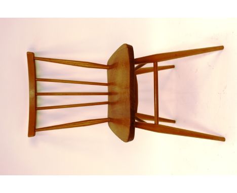 A set of four Ercol stick back dining chairs 