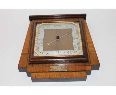 An Art Deco mahogany, walnut and satinwood cross banded barometer with presentation inscription