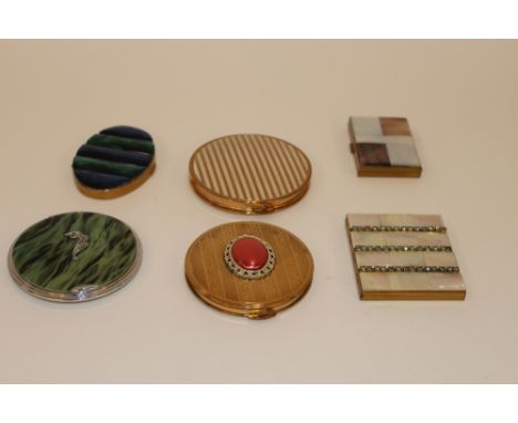 Six vintage decorative powder compacts, including mother of pearl and enamel decorated examples 