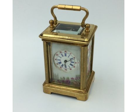 Brass cased miniature carriage clock with 8 day movement &amp; porcelain panels, with key 