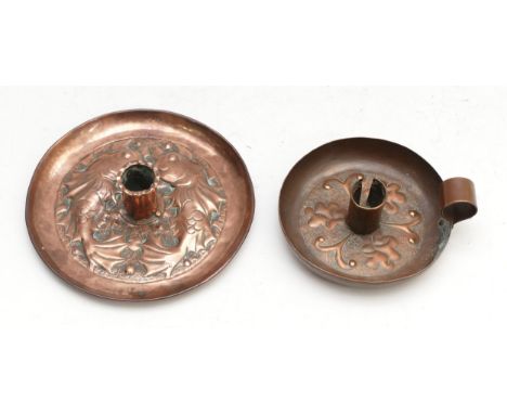 A Newlyn School Arts and Crafts copper candlestick, with repousse decoration featuring fish and foliage, 16cm and a smaller c