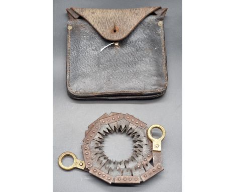 A British field chainsaw, in leather pouch, (incomplete).