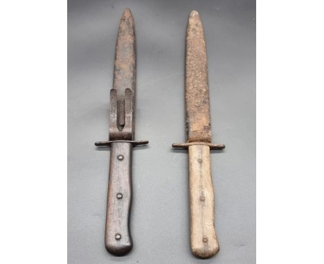 A trench knife and scabbard,&nbsp;with 16cm single edged clip back blade; and another similar, (each s.d.). (2)