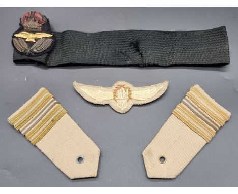 A Royal Air force WWII period officers cap badge; together with an RAF pilots tropical wings and epaulettes. (4)