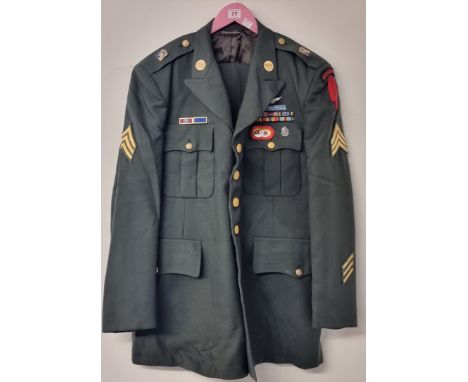 A US Army Special Forces sergeant's dress tunic, trousers and parachute beret,&nbsp;all with insignia.