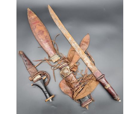A West African Mandingo sword and leather scabbard, with 43.5cm blade; together with a North African arm dagger and leather s