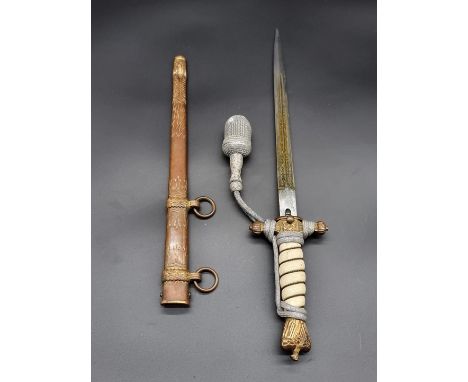 A WWII German Kriegsmarine dagger and scabbard, by Weyersberg, Kirschbaum &amp; Cie, with 25cm etched blade, and attached por