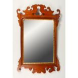 A GEORGE III STYLE MAHOGANY FRETWORK FRAMED WALL MIRROR. 70cms high x 44cms wide.