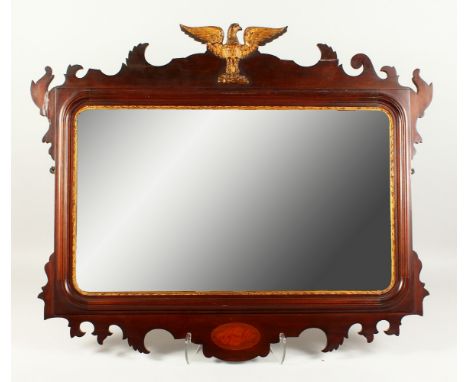 A GEORGIAN STYLE MAHOGANY FRETWORK FRAMED MIRROR, with shell inlay and eagle finial. 80cms high x 90cms wide.