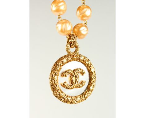 A LARGE PEARL NECKLACE, with Chanel logo pendant, in original ribbon bound box.