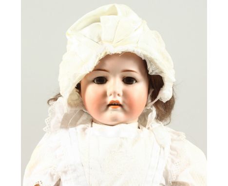 MAX HANDWERCK (1899-1930) GERMAN A RARE BISQUE HEADED YOUNG GIRL DOLL, with long hair and articulated body. 1ft 11ins long.