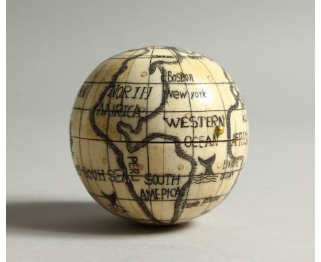 A BONE FOLDING POCKET GLOBE/COMPASS. 7cms diameter.