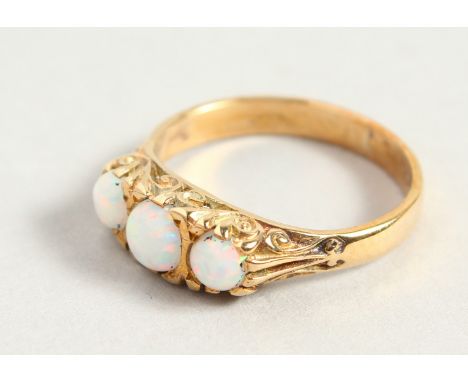 A 9CT GOLD THREE-STONE OPAL RING.