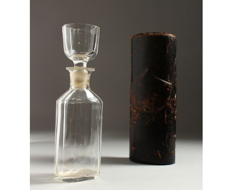 AN UNUSUAL 19TH CENTURY GLASS FLASK, the stopper also forming a cup, in a leather case. 21cms high.