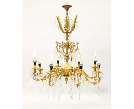 A LARGE LOUIS XVI DESIGN GILT METAL EIGHT BRANCH CHANDELIER with scrolling branches and with over 200 cut crystal drops. 2ft 