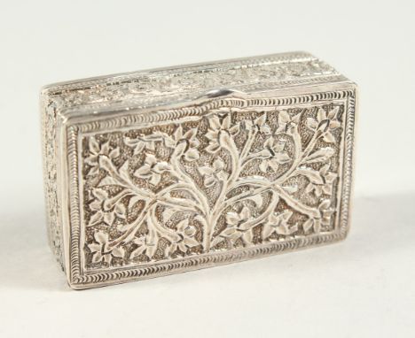 A CONTINENTAL SILVER SNUFF BOX DECORATED WITH TREES, the sides with a continuous border of motifs. 2ins long.