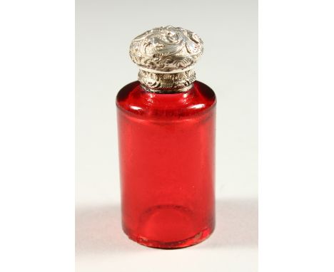 A VICTORIAN CIRCULAR RUBY GLASS SCENT BOTTLE with repousse silver screw off top. 6.5cms high (base A/F).