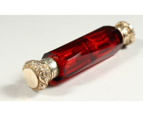 A VERY GOOD VICTORIAN FACET CUT RUBY GLASS DOUBLE ENDED SCENT BOTTLE with repousse tops and glass stopper. 12.5cms high.