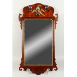 A GEORGIAN STYLE MAHOGANY FRETWORK FRAMED WALL MIRROR, with ho-ho bird crest. 86cms high x 47cms