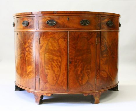 A GEORGE III DESIGN MAHOGANY BOWFRONT COMMODE, EARLY 20TH CENTURY, with quarter veneered top, oak leaf banding above a centra