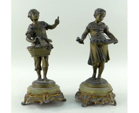 PAIR OF FRENCH PATINATED BRONZE FIGURES OF PEASANT YOUTHS, with fruit and flower baskets, on onyx and gilt bronze rococo base