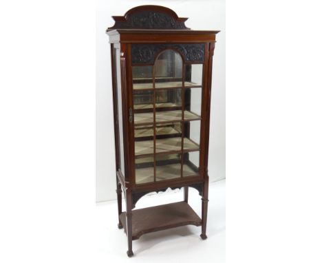 LATE VICTORIAN CARVED MAHOGANY DISPLAY CABINET, arched back, bevel glass fitted door and sides, fluted angles, platform stret