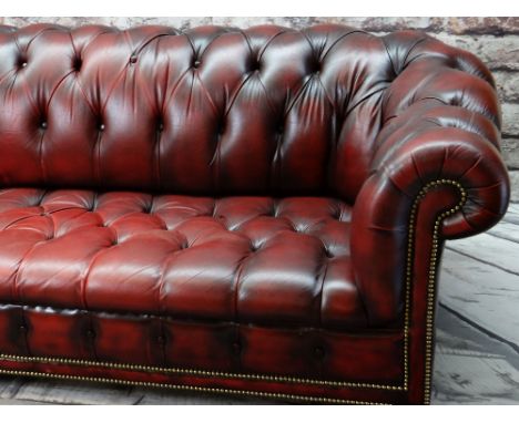 VICTORIAN-STYLE LEATHER CHESTERFIELD SOFA, red button upholstered and close nailed on turned feet, 214 x 91cms Condition Repo