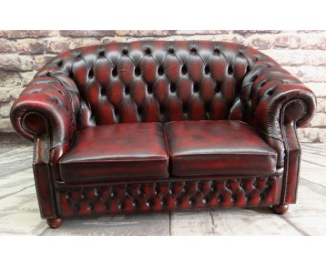 MODERN VICTORIAN-STYLE BURGUNDY LEATHER SETTEE, button upholstered and close-nailed, bun feet, 162cms wide Condition Report: 