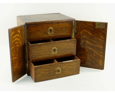 EDWARDIAN OAK THREE-DRAWER TABLE CABINET, fitted deep drawers with flush handles, similar side handles, formerly used for cig