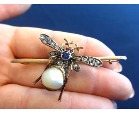 An antique 'bug' brooch, set with diamonds, rubies, a sapphire and a baroque pearl, in a yellow metal setting, wing diameter 