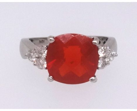 A Mexican fire opal ring set with nine further round cut diamonds in white gold, stamped 18k, ring size N/O.