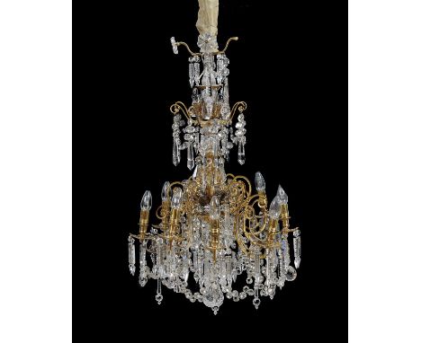 A gilt metal and cut glass eight branch chandelier in Louis XV style 19th century, the s-scrolled and openwork cast frame hun