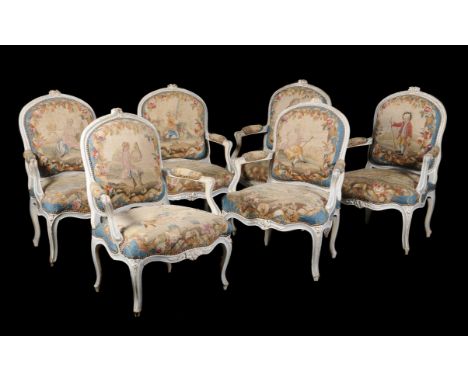 A French carved white-painted salon suite in Louis XV style, 19th century, with Aubusson style upholstery depicting figures i