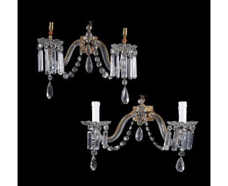 A set of four Victorian cut and moulded glass and gilt metal mounted twin light lustre wall appliques, second half 19th centu