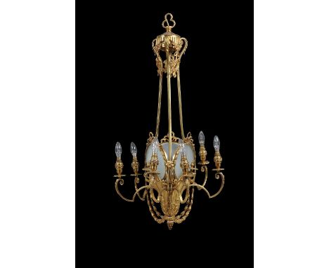 A Belle Epoque gilt metal and frosted glass seven light chandelier, circa 1900, the scrolled arms issuing from a tripartite f