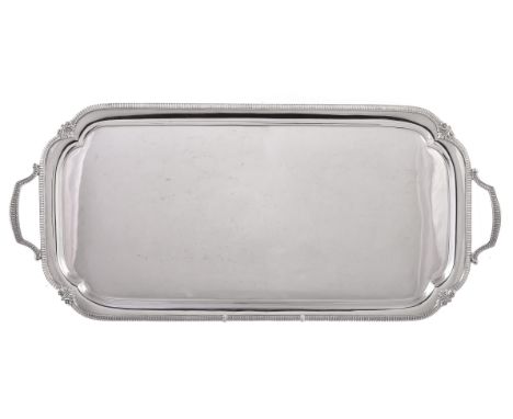 A silver twin handled drinks tray by Harrison Brothers & Howson, Sheffield 1929, rectangular, the inset angles with shells, a